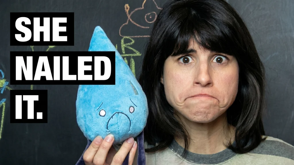 redRomina making a frowning face to match the nervous expression of the blue Water plush toy from the Raven Stitch collection.