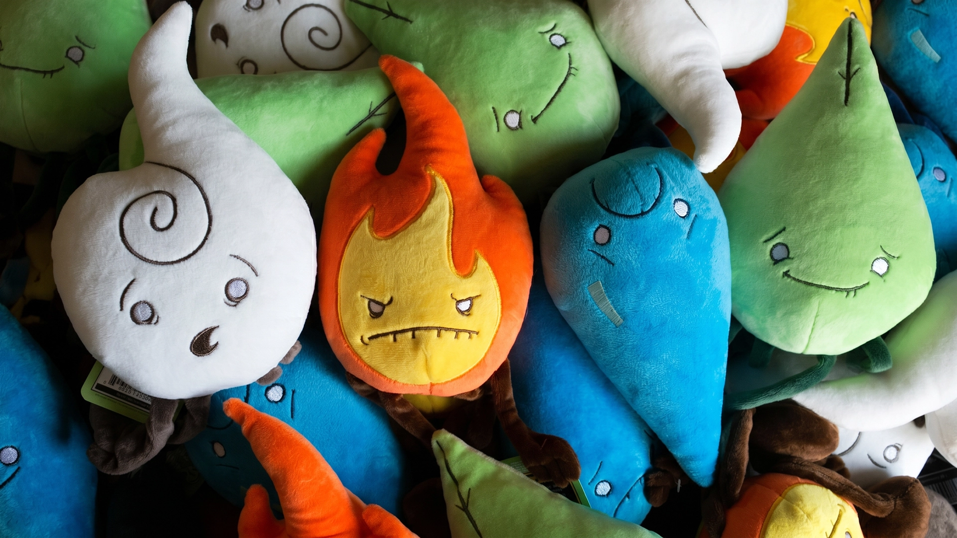 A colorful pile featuring the full collection of Raven Stitch Plush Elements: the grumpy orange Fire, the nervous blue Water, the smiling green Earth, and the surprised white Air spirits.