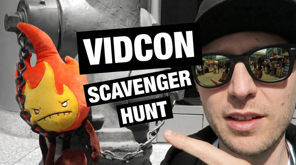 Denis Caron pointing at a Fire Plush Element hidden on a silver fire hydrant as part of a scavenger hunt at the Anaheim Convention Center.