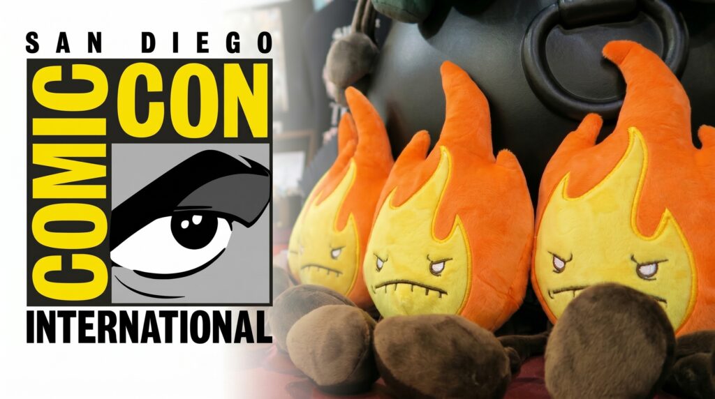 The San Diego Comic-Con International logo placed next to a row of three Fire Plush Elements sitting in front of a black cauldron.